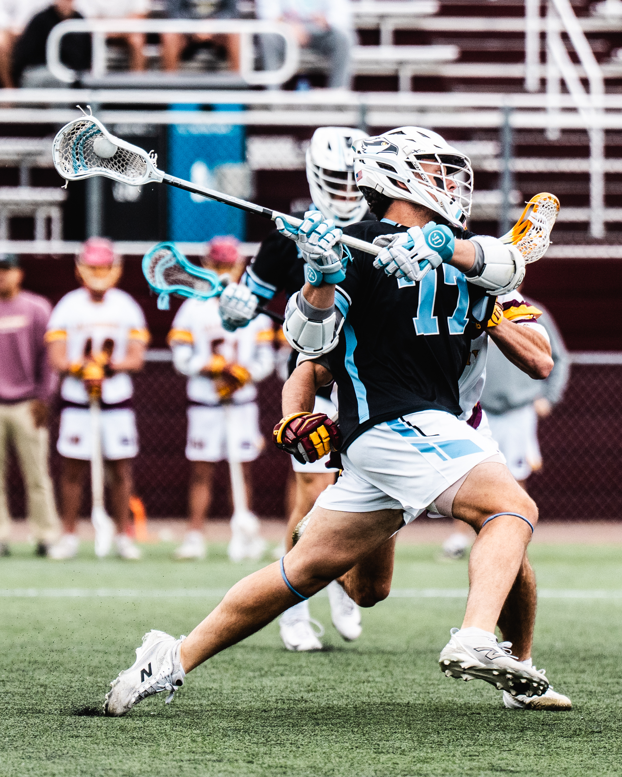 Coach Alex DeLierre coaching a youth lacrosse player
